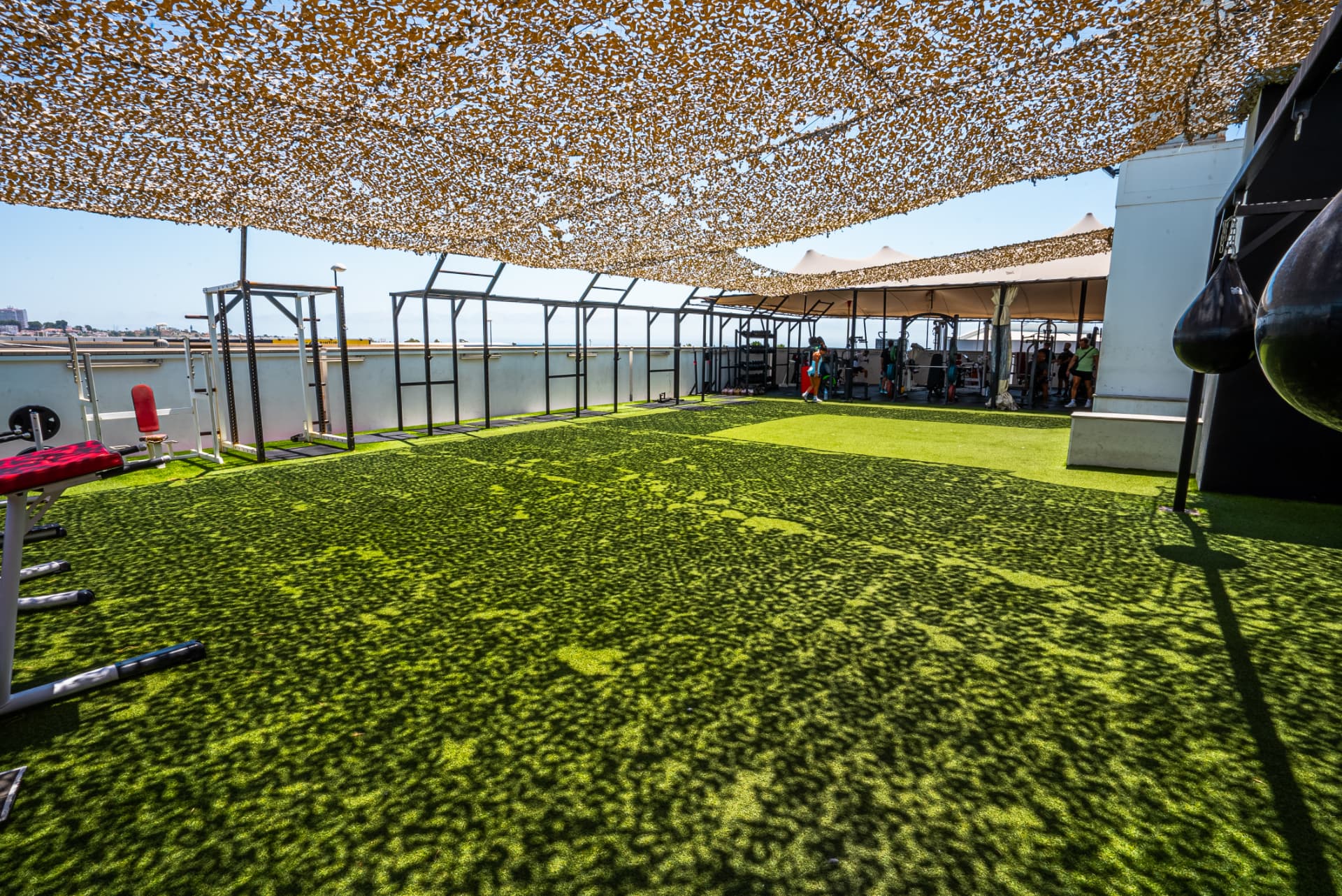 Elements rooftop outdoor training terrace with turf, rigs and shade netting